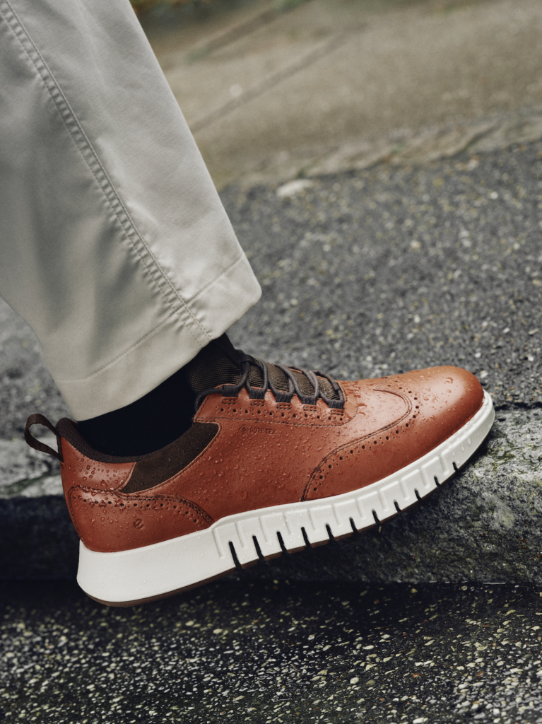 A lifestyle shot of the ECCO Gruuv waterproof wingtip shoes.