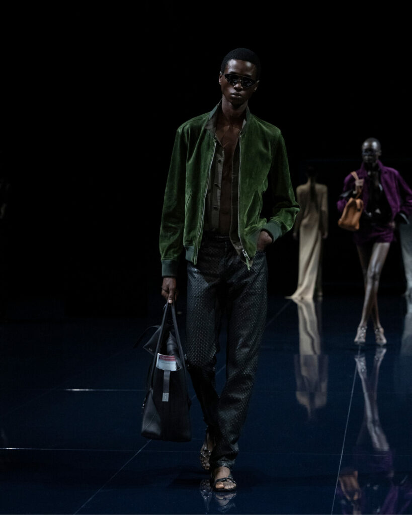 A model wears a suede green bomber jacket from the Tom Ford Spring/Summer 2026 collection.