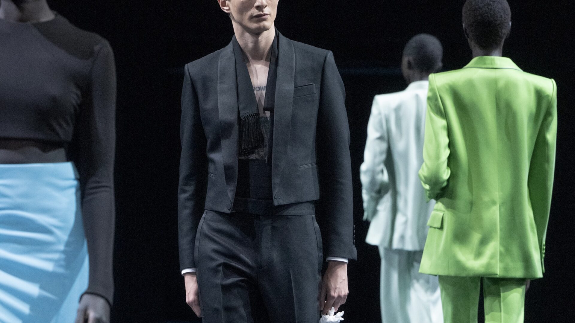 A close-up of a model walking the Tom Ford Spring/Summer 2026 runway show at Paris Fashion Week.
