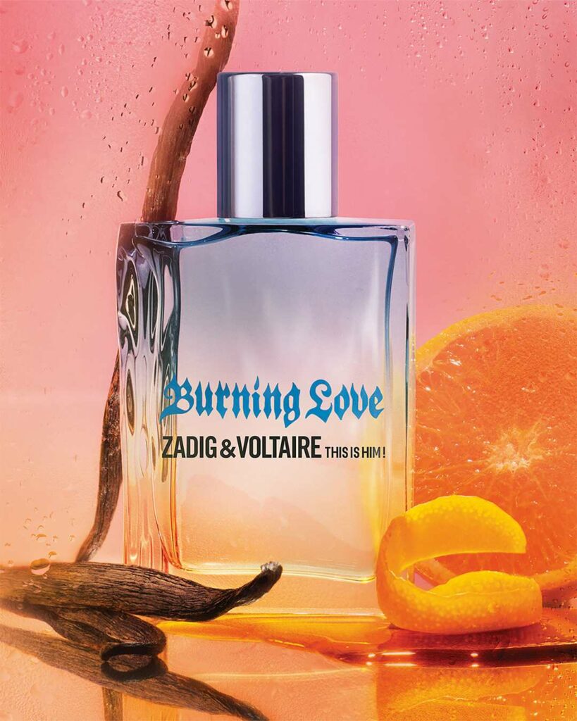 Zadig&Voltaire Burning Love perfume bottle set against an orange backdrop