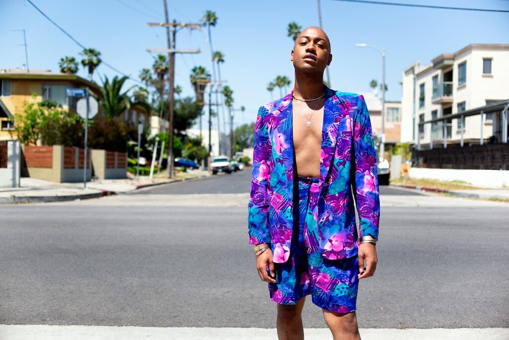 Model Grey Cotton in a pink and purple floral shorts and blazer combo standing on a street (Image: Elska/Liam Campbell)