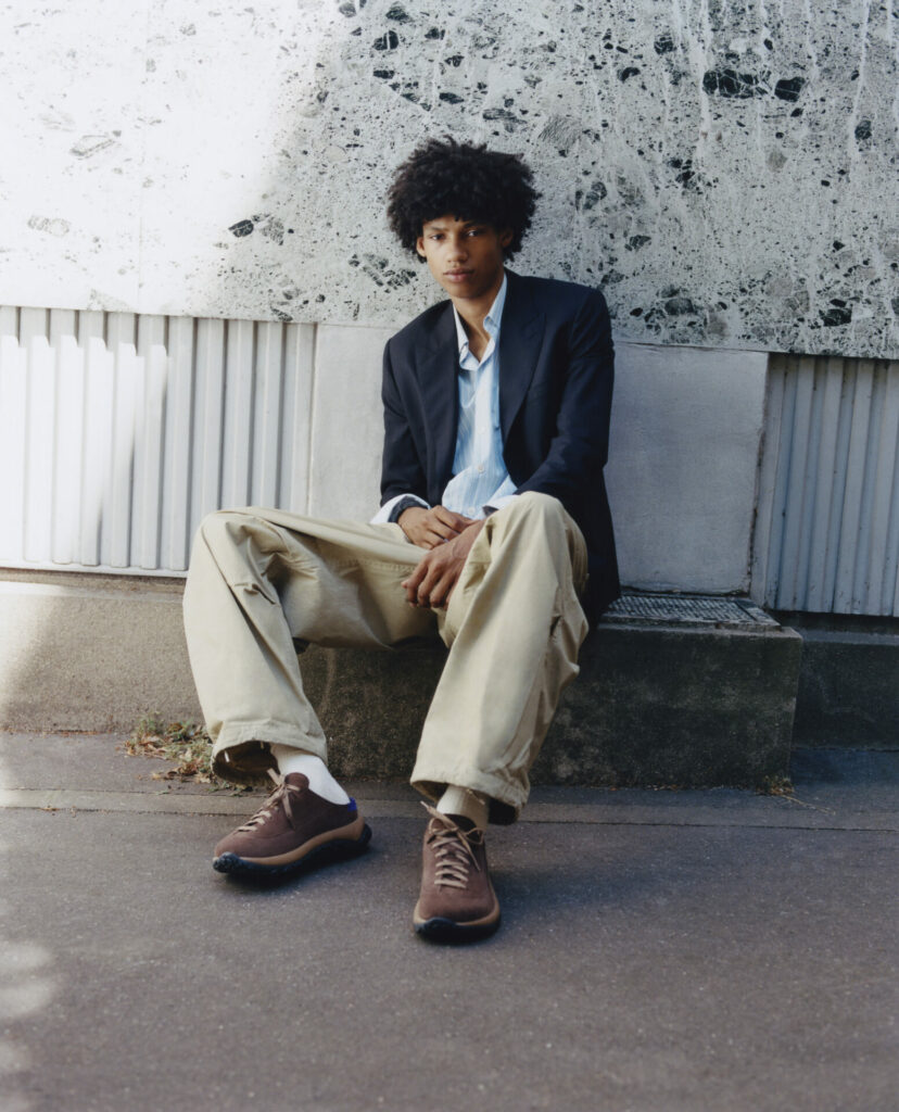 A model wears Birkenstock 1774 suede slip-ons.