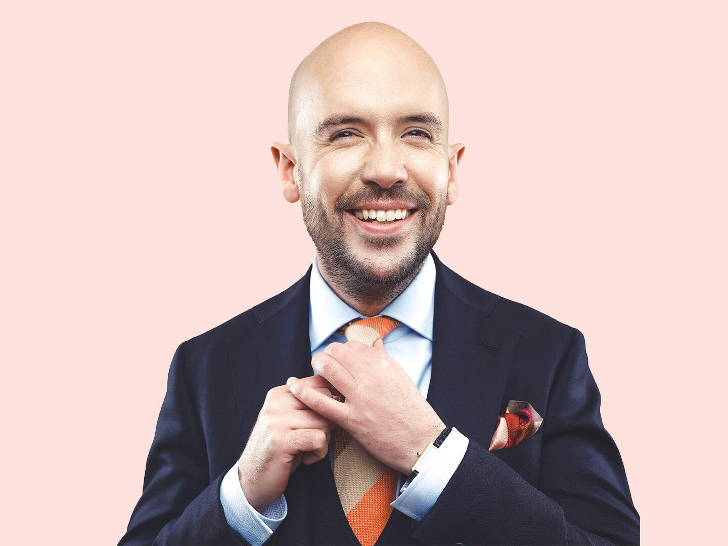 Tom Allen in a suit and tie smiling 