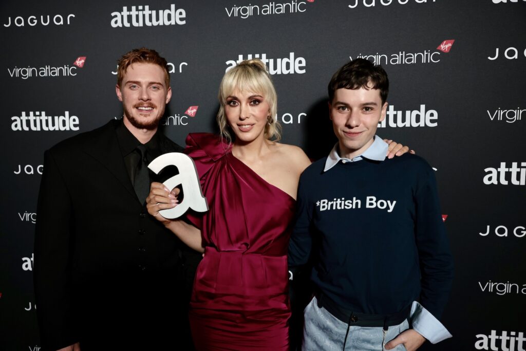 Max Parker in black, Paris Lees in red one shoulder dress and Ellis Howard in a blue sweater with the words 'British Boy' on it