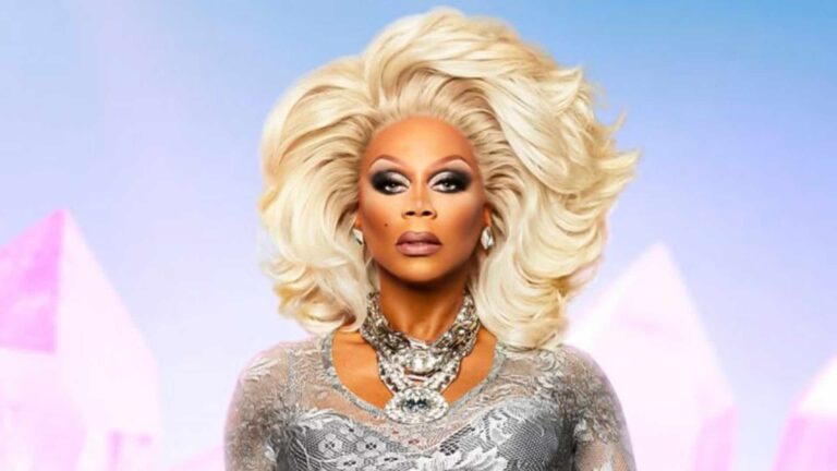 RuPaul in a blonde wig and silver dress