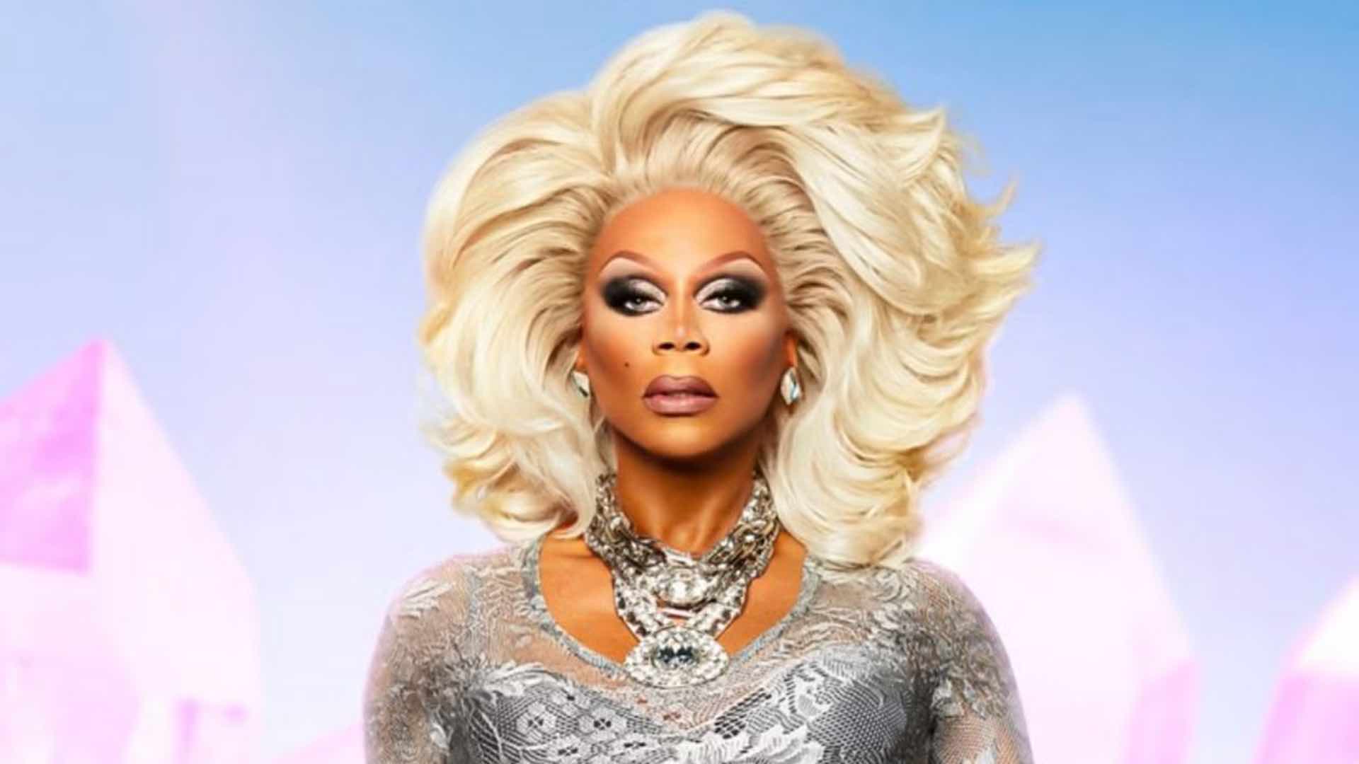 RuPaul in a blonde wig and silver dress