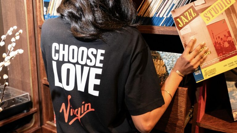 A lifestyle shot of the Virgin and Choose Love "Remasted" collection charity T-shirts