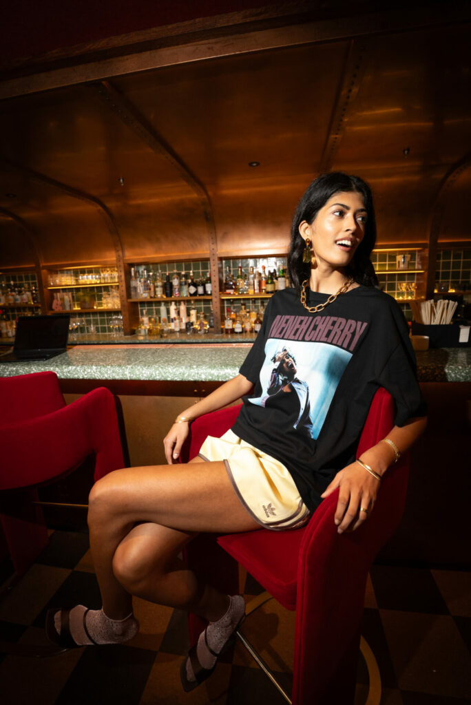 A lifestyle shot of the Virgin and Choose Love "Remasted" collection charity T-shirts featuring Neneh Cherry.