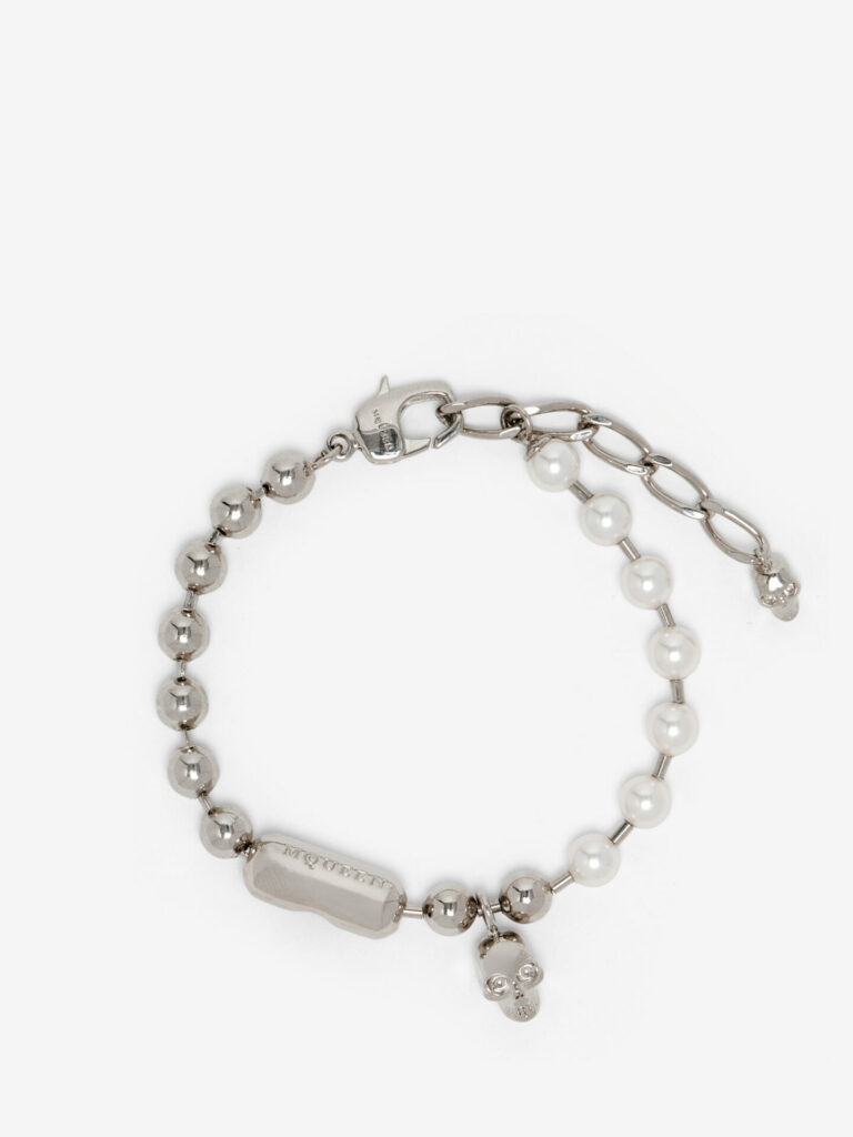 Product shot of a palladium bracelet from Alexander McQueen featuring a skull and pearls featured in Attitude's 2025 luxury gift guide