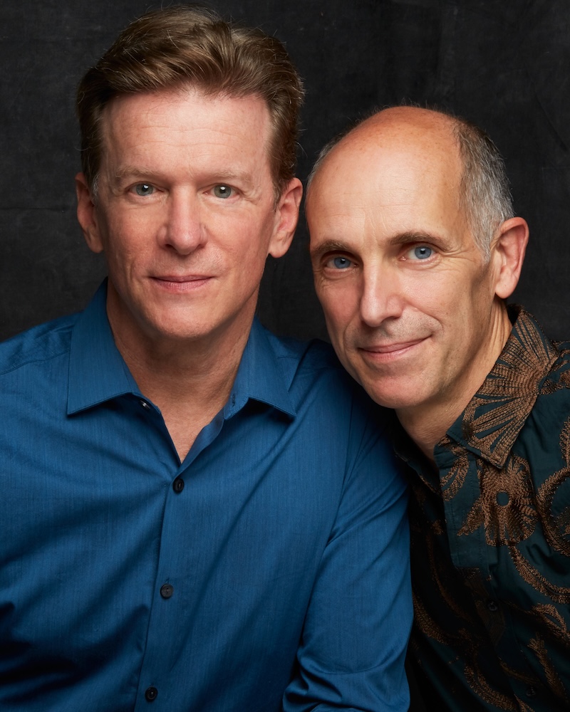 The book's creators, Hugh and Neal, colour image, one in blue shirt one in a patterned green shirt