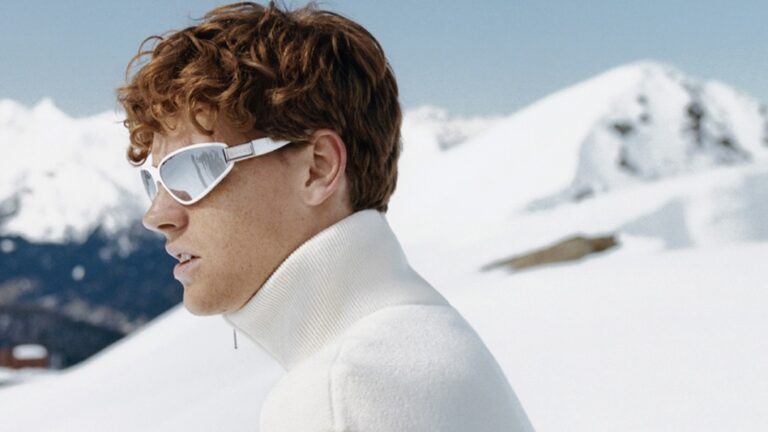 Athlete Jannik Sinner models the Gucci Altitude skiwear collection against the snowy expanse of the mountain top wearing Gucci ski-inspired frames.