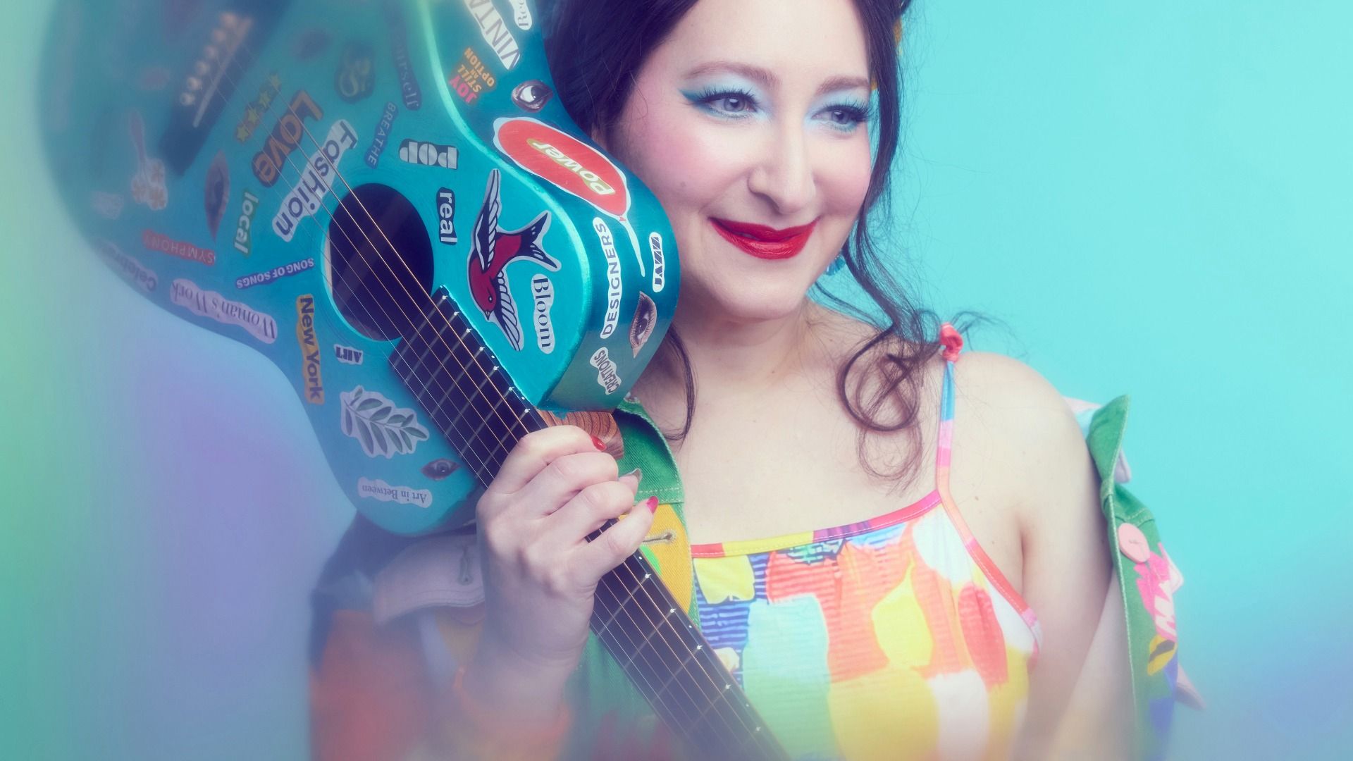 Rachael Sage holding a blue guitar