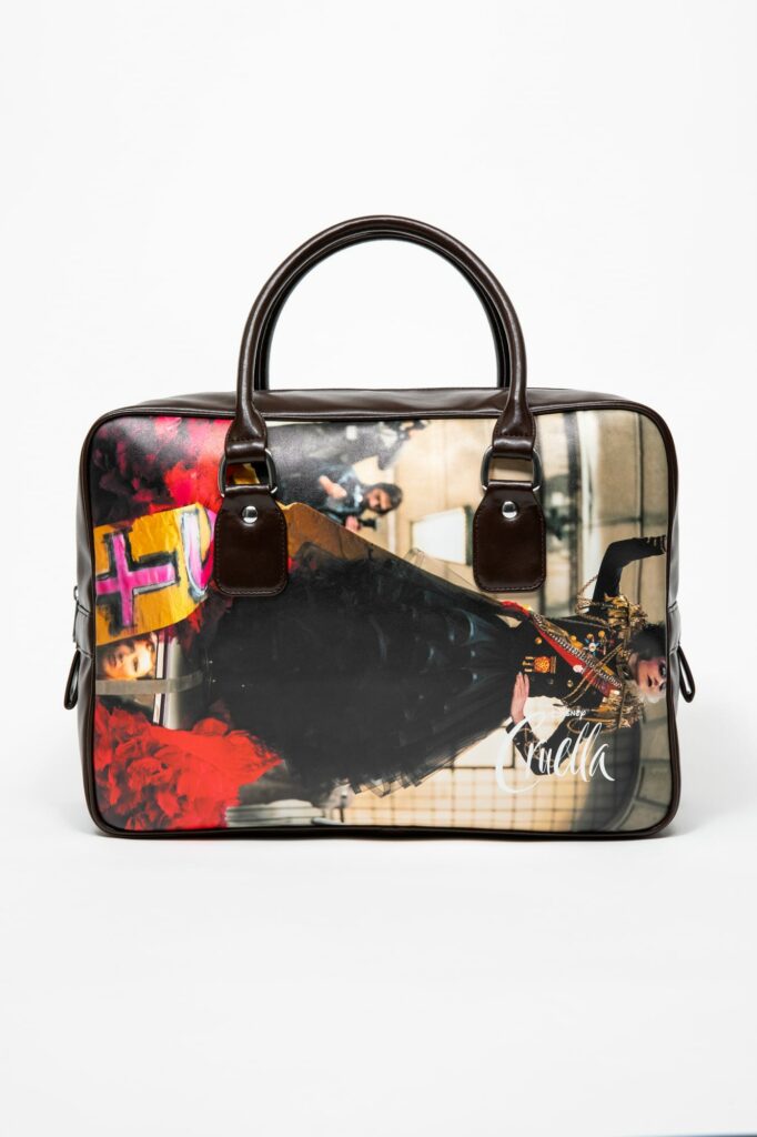 A product shot of the Comme des Garçons bag in collaboration with Selfridges and Disney featuring an image of Cruella starring Emma Stone.