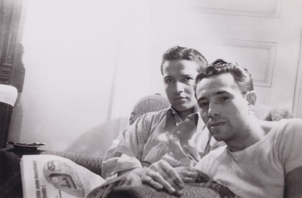 a male couple in black and white sitting on a sofa