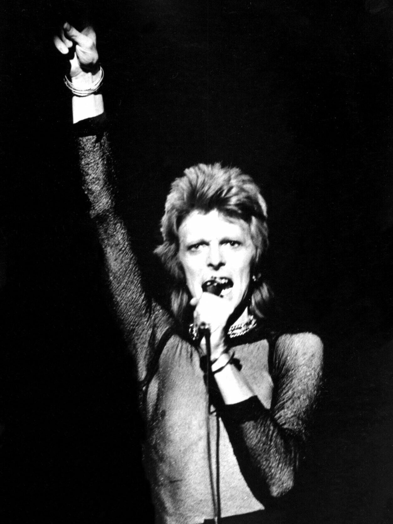 David Bowie black and white with his fist in the air