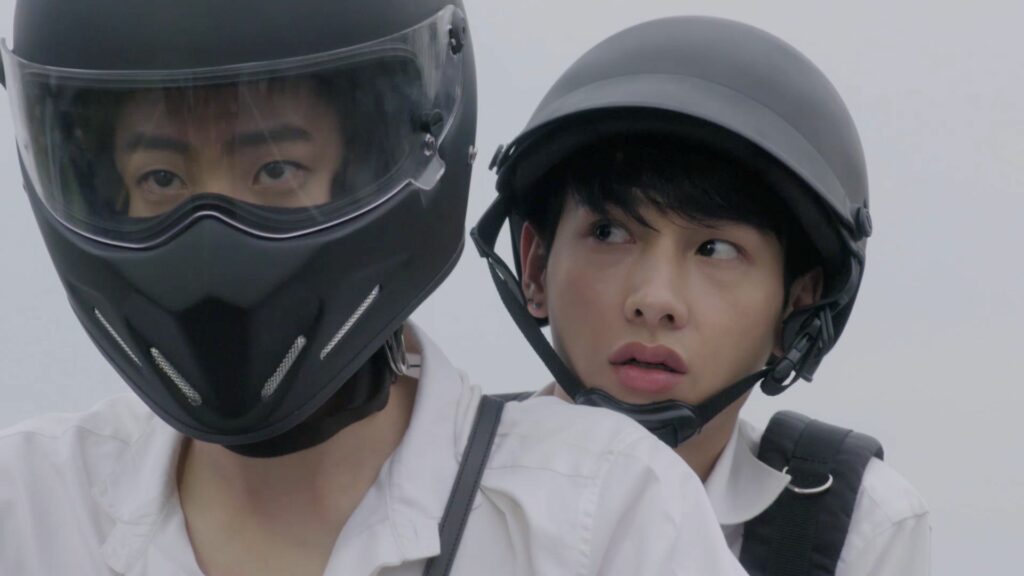 Two men riding a motorcycle in Thai BL series Theory of Love