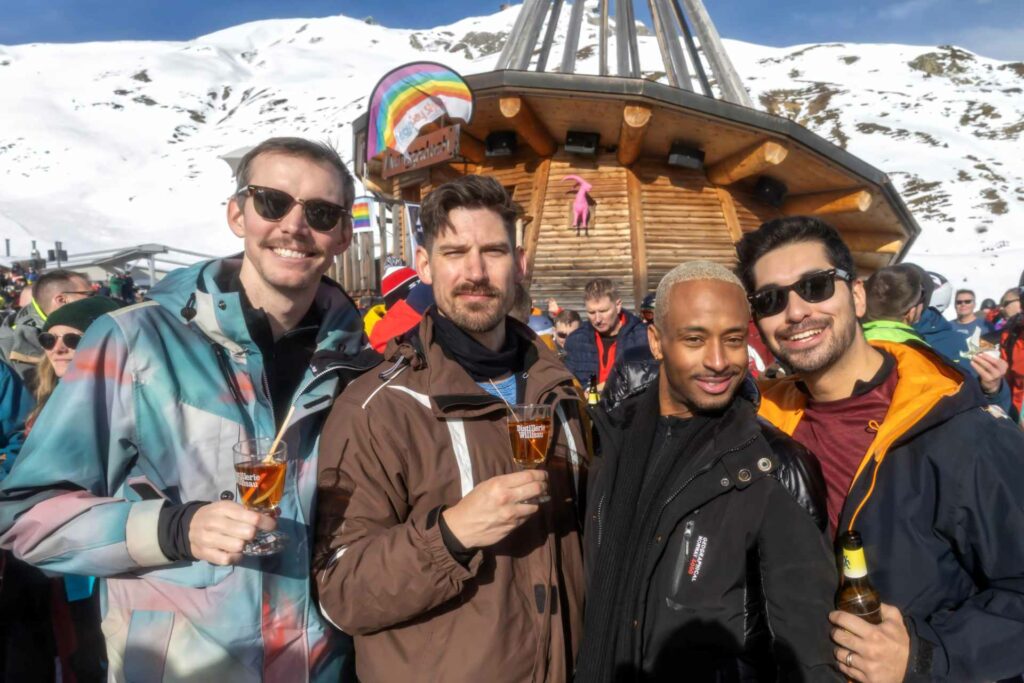 A group of smiling people holding drinks at the Arosa skiing resort