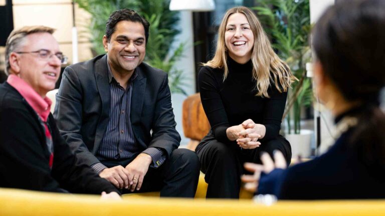A group of business colleagues sitting around chatting in a candid shot