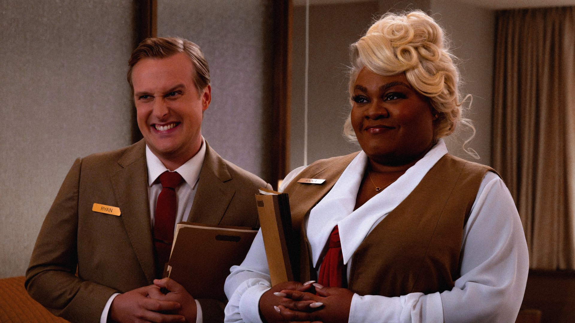 a still from the film showing the interviewees in character in the film, wearing uniforms and holding clipboards, smiling