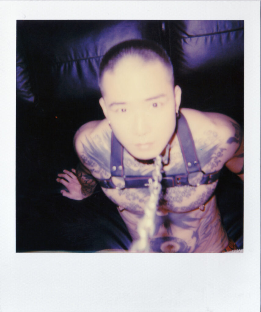 Holy Days (XII) &copy; Matheus Katayama - a picture a man a tattooed man sat down in a harness with rope around his neck