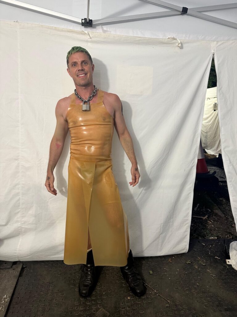 Jake Shears behind the scenes in Pillion in a late apron