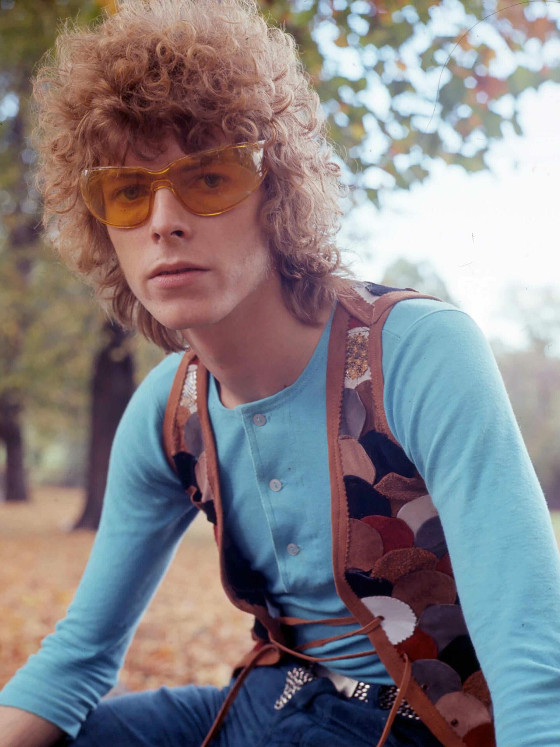 David Bowie in orange sunglasses with curly hair