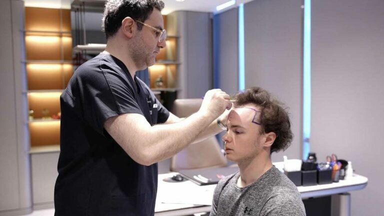 A doctor performing a hair transplant consultation on a patient