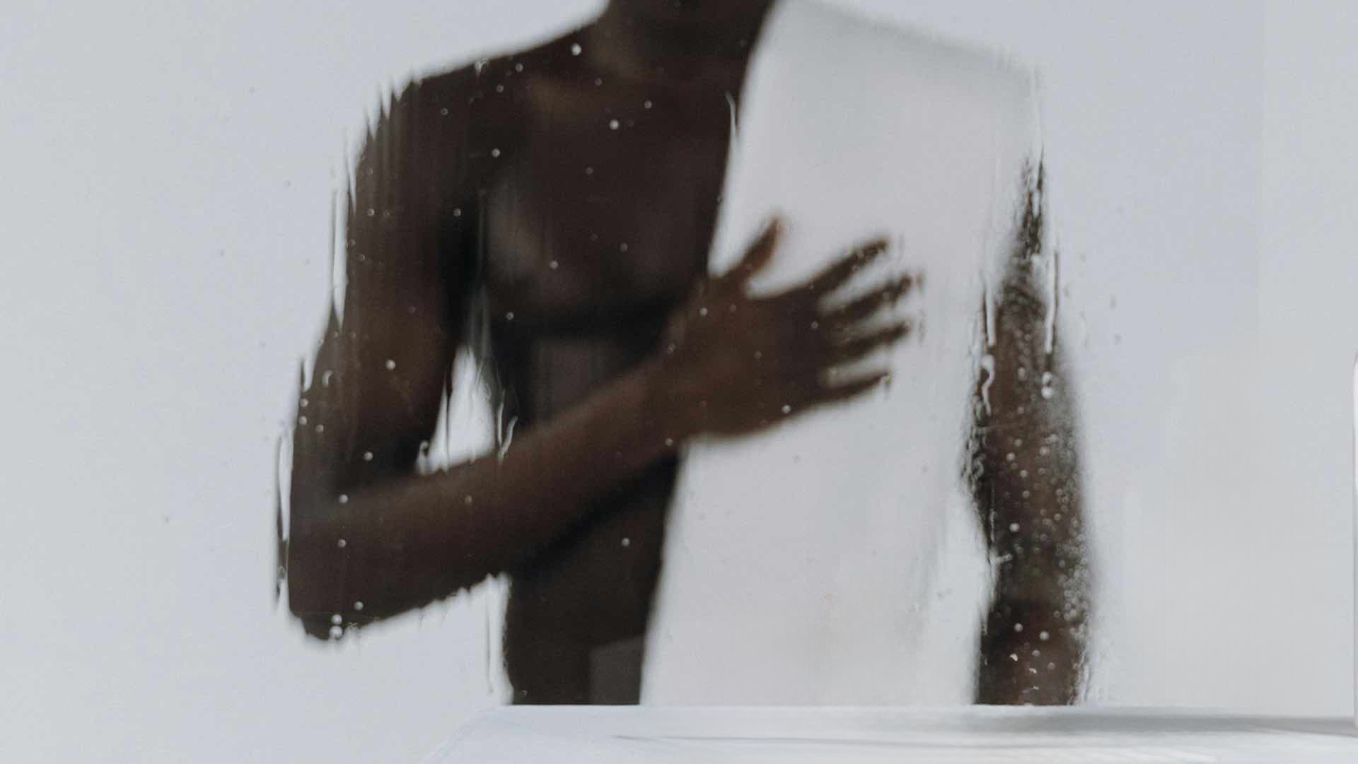 Shirtless man with a towel over his shoulder