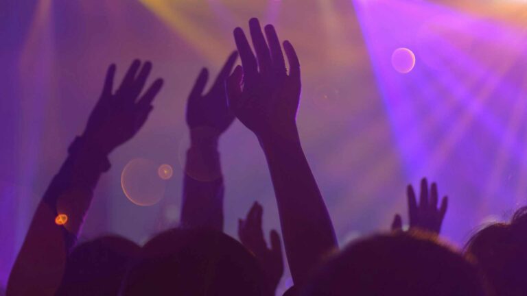 Close up of hands of people on a dance floor