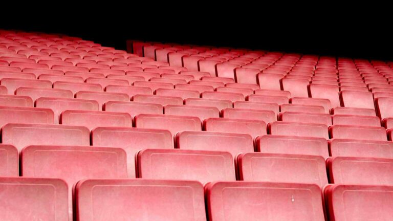 Rows of empty red cinema seats