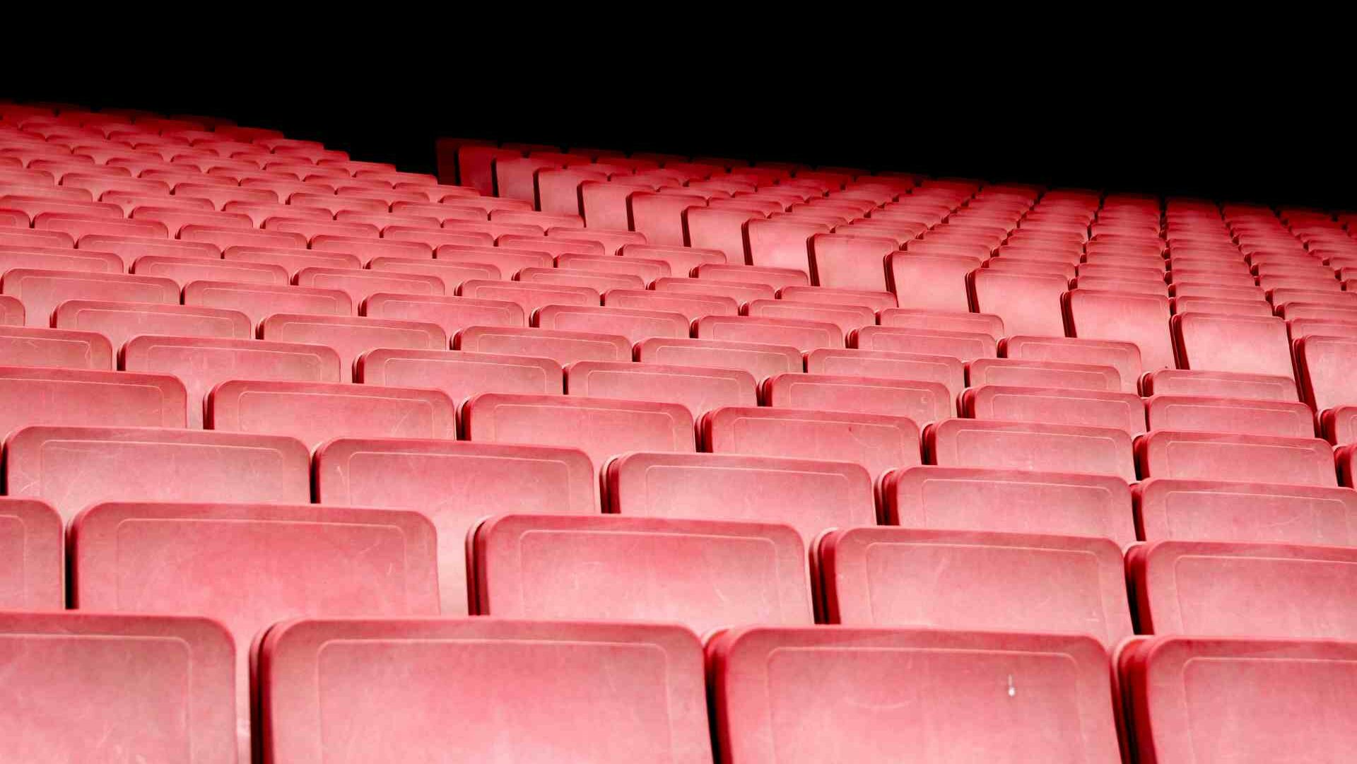 Rows of empty red cinema seats