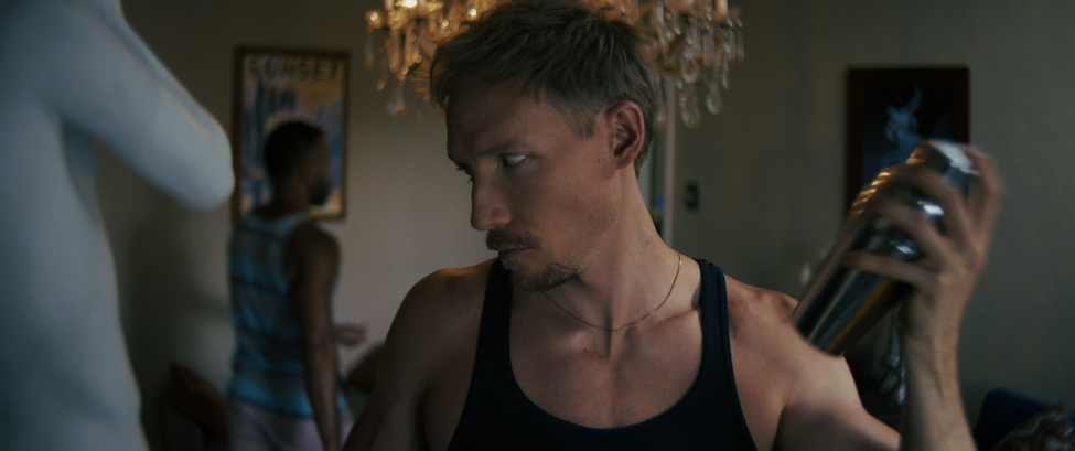 Ethan Daniel Corbett in Laid Bare shaking a cocktail mixer