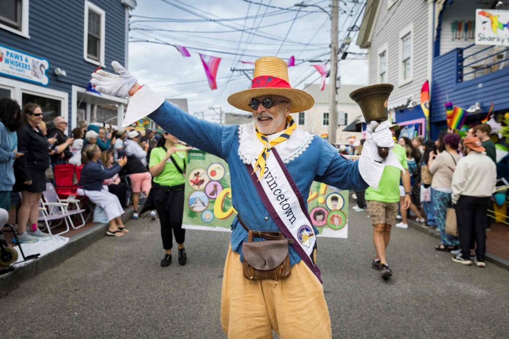 A person in costume taking part in the Provincetown Carnival parade along Commercial Street