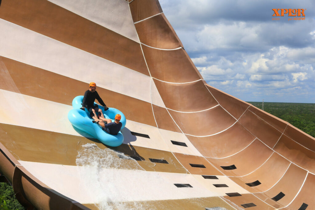 Two people ride a water slide at Mexico's Xplor adventure park ride