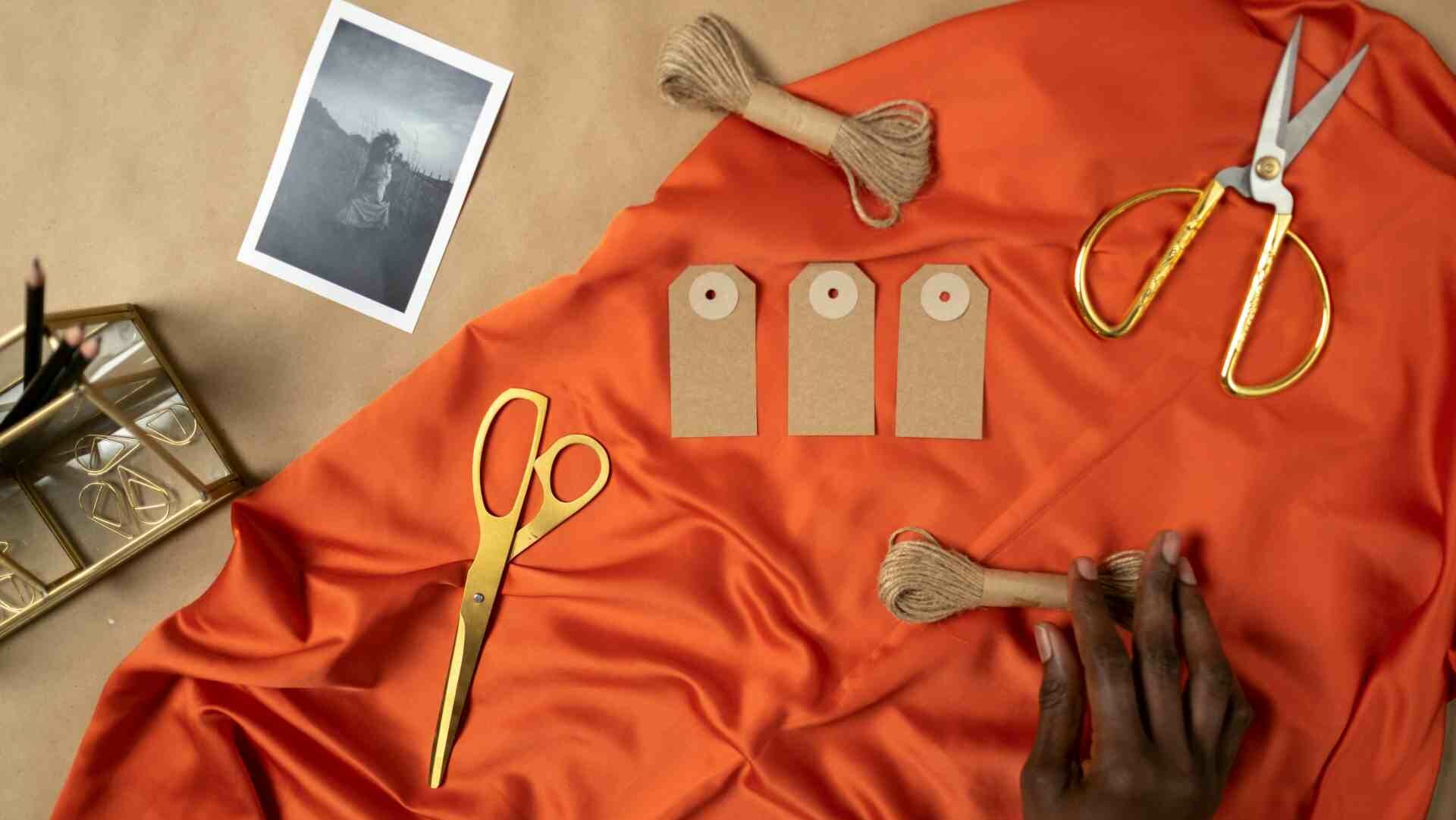 An prange sheet with craft items laid across it like scissors and cotton