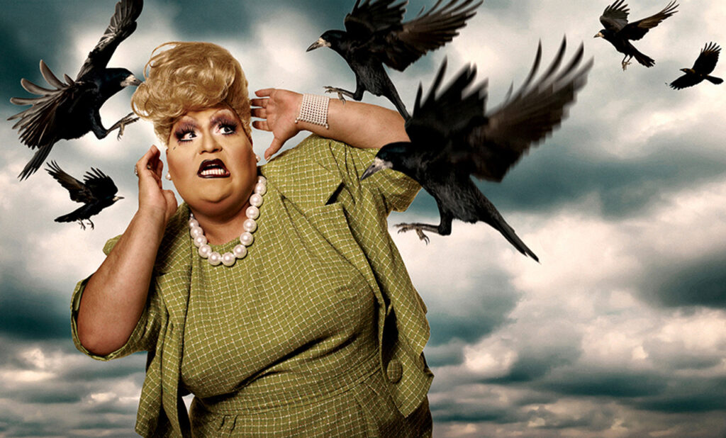 Dulce de Leche in a green outfit being attacked bu crows, in a shot inspired by The Birds