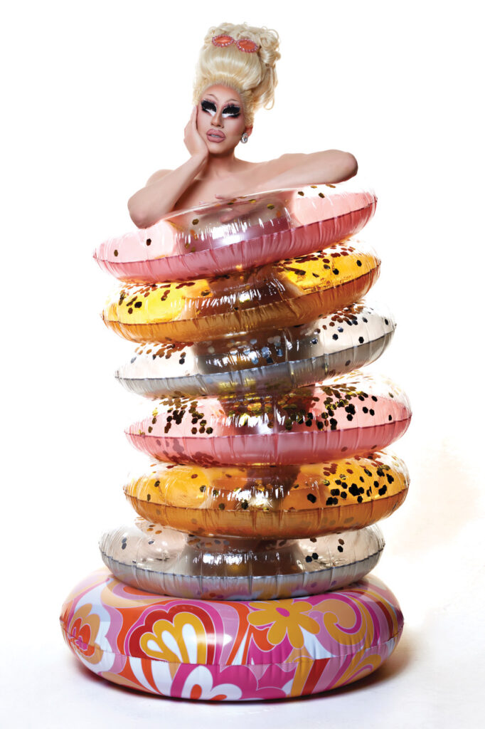 trixie mattel inside a series of rubber rings which appear like a dress