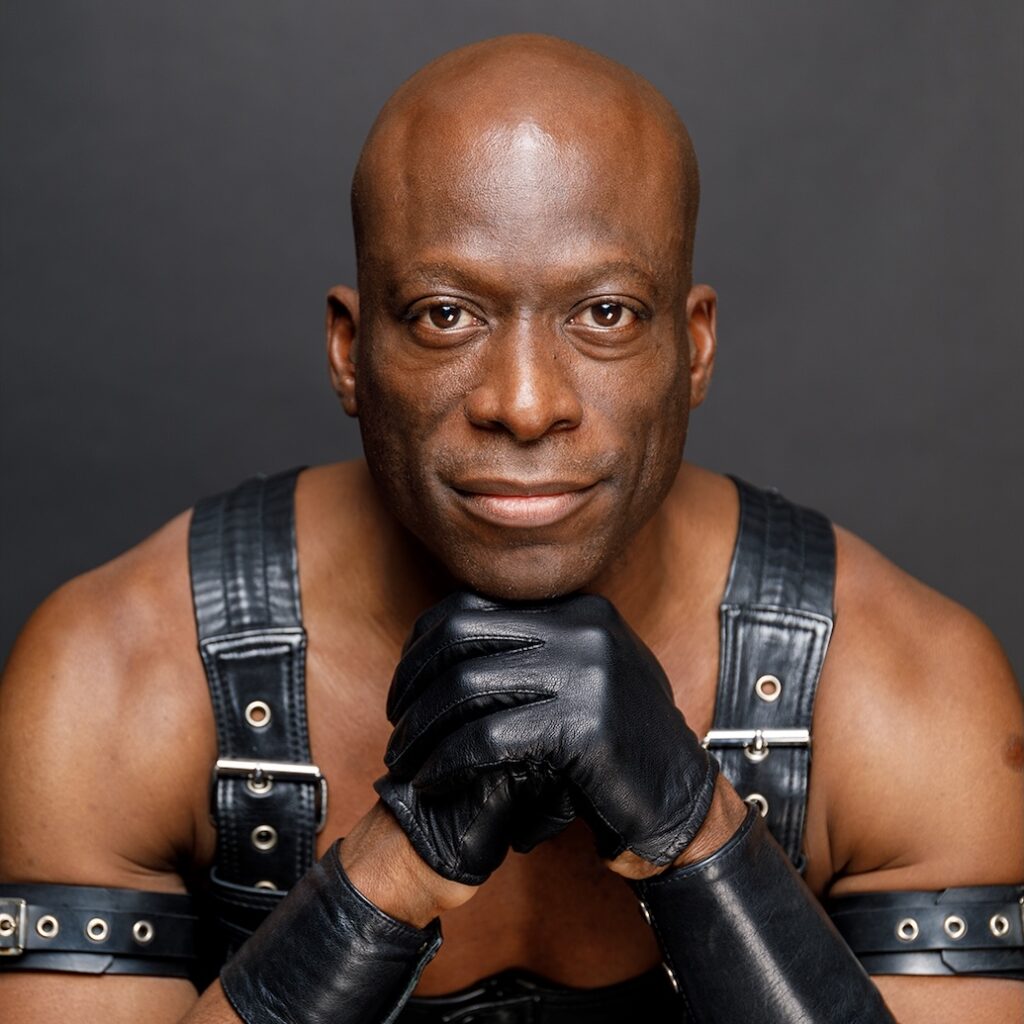 contributor Antoin Strachan topless in black leather harness and gloves