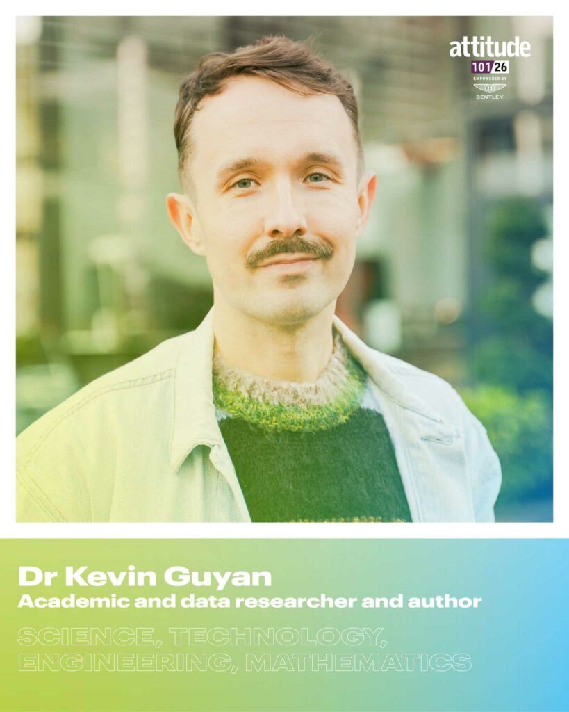 Dr Kevin Guyan standing outdoors in a light jacket and knit jumper, looking at the camera, with the Attitude 101 logo visible in the top corner.