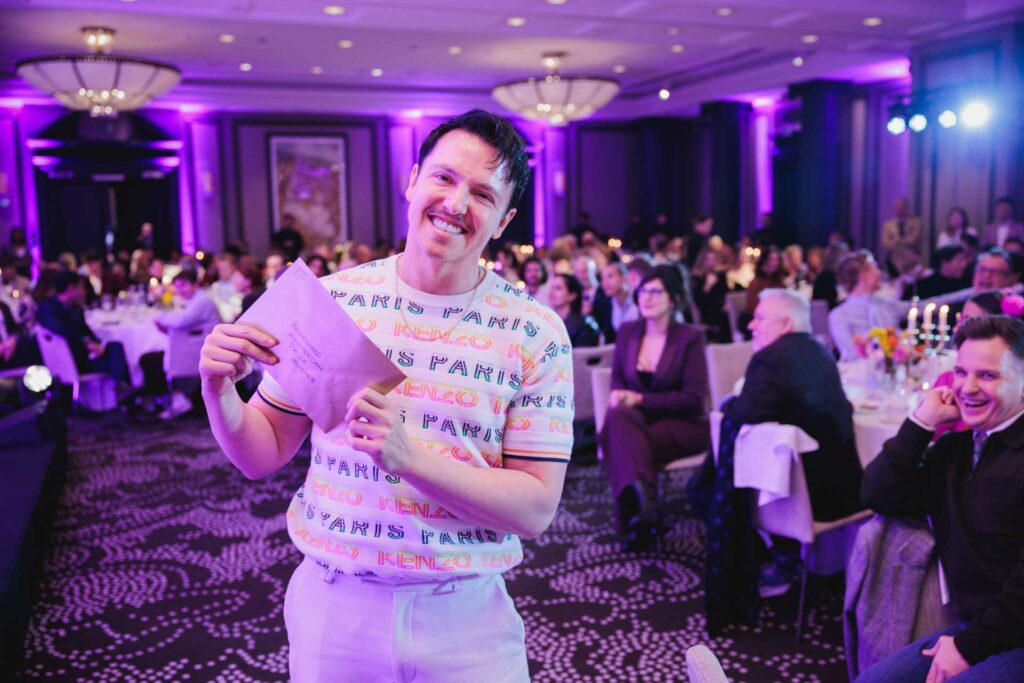 Simon Jones holding an envelope at the Attitude 101 2026 event