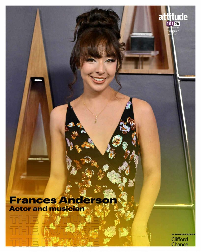 Frances Anderson smiling in a black floral dress, standing in front of wooden display shelves, with the Attitude 101 logo visible in the top corner.