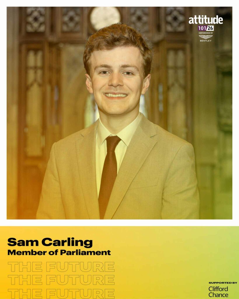 Sam Carling smiling in a beige suit and tie, standing indoors in front of ornate wooden doors, with the Attitude 101 logo visible in the top corner.