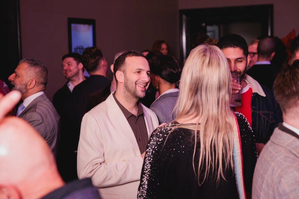 Zack Polanski chats with guests at the Attitude 101 reception