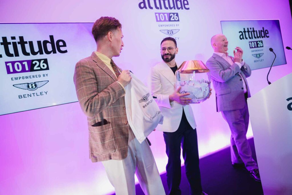 Three people drawing a raffle on stage at the Attitude 101 2026 event