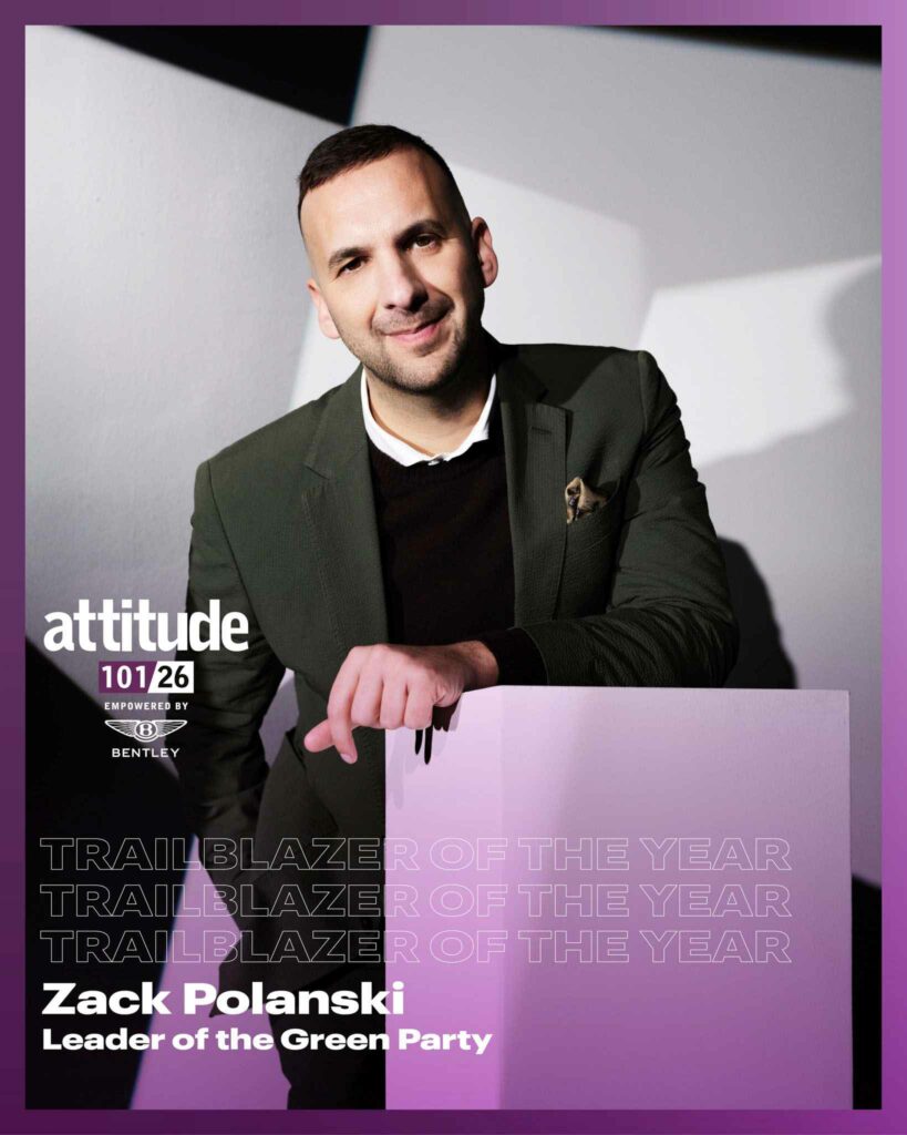 ortrait of Zack Polanski standing behind a pale rectangular plinth, wearing a dark blazer over a dark top with a pocket square. The background features soft geometric light and shadow. Overlaid text reads &ldquo;Trailblazer of the Year&rdquo; and &ldquo;Zack Polanski, Leader of the Green Party&rdquo;, alongside the Attitude 101, empowered by Bentley, logo.