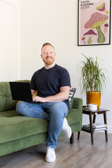 Daniel O&rsquo;Shaughnessy smiling on his laptop