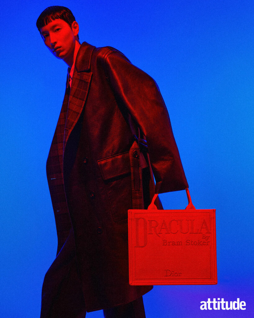 Menswear editorial featuring a model wearing a leather trench by Dunhill and Dracula tote bag by Dior