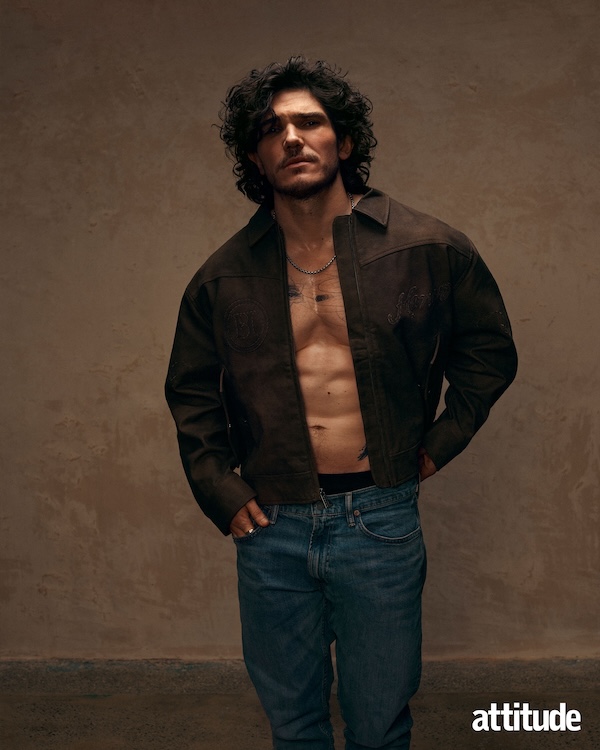 Fra Fee, wearing an open brown jacket with nothing underneath paired with blue jeans 