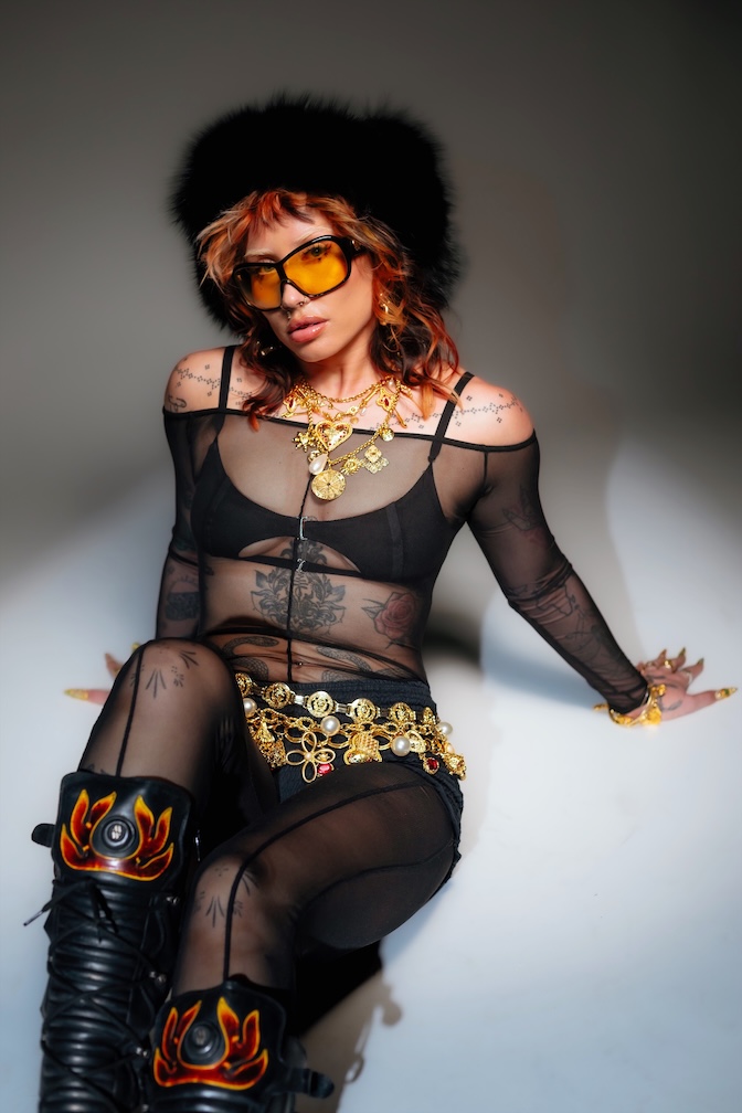 Kaya wore a sheer bodysuit over black underwear, paired with orange sunglasses and a fluffy hat