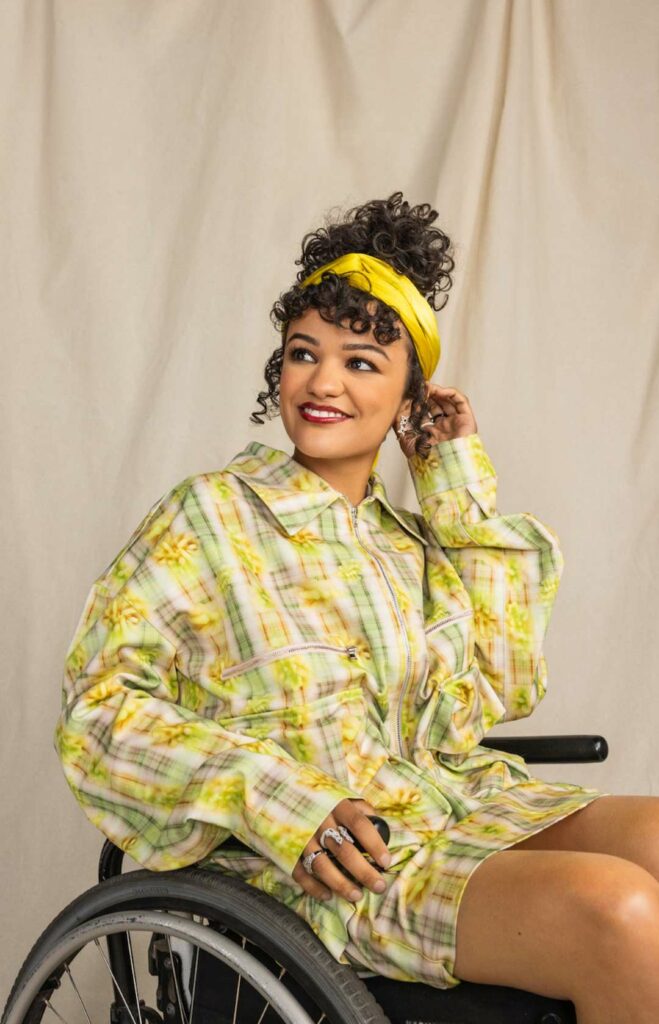 Marissa Bode wearing a colourful yellow outfit sitting in a wheelchair